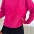 Fuchsia sweater with pearls and textured pattern